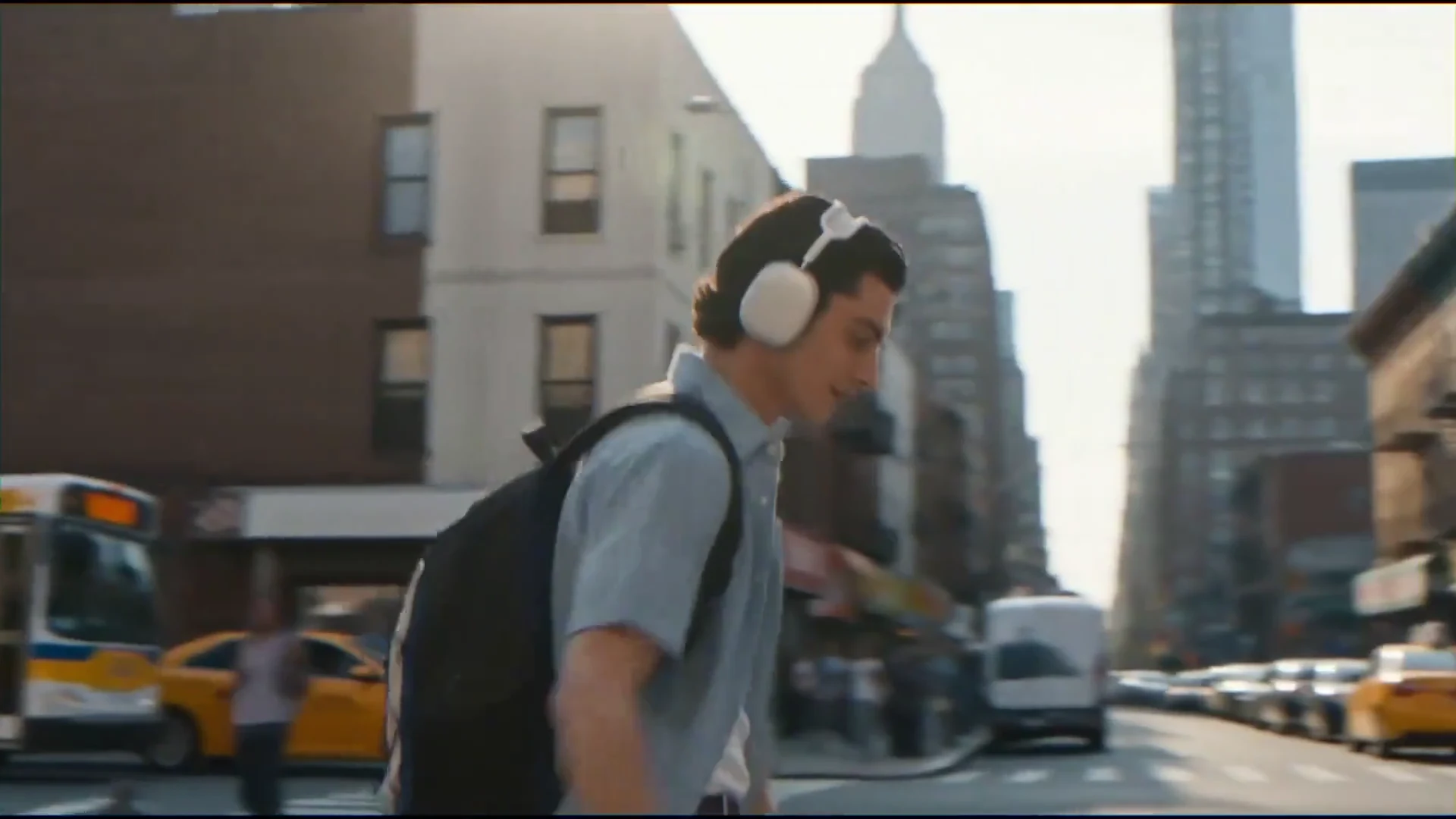 A man wearing headphones on a city street