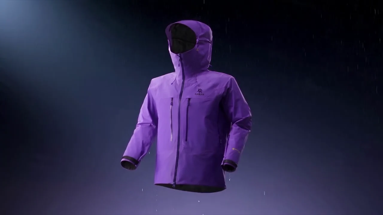 A purple hooded outdoor jacket suspended against a dark blue background