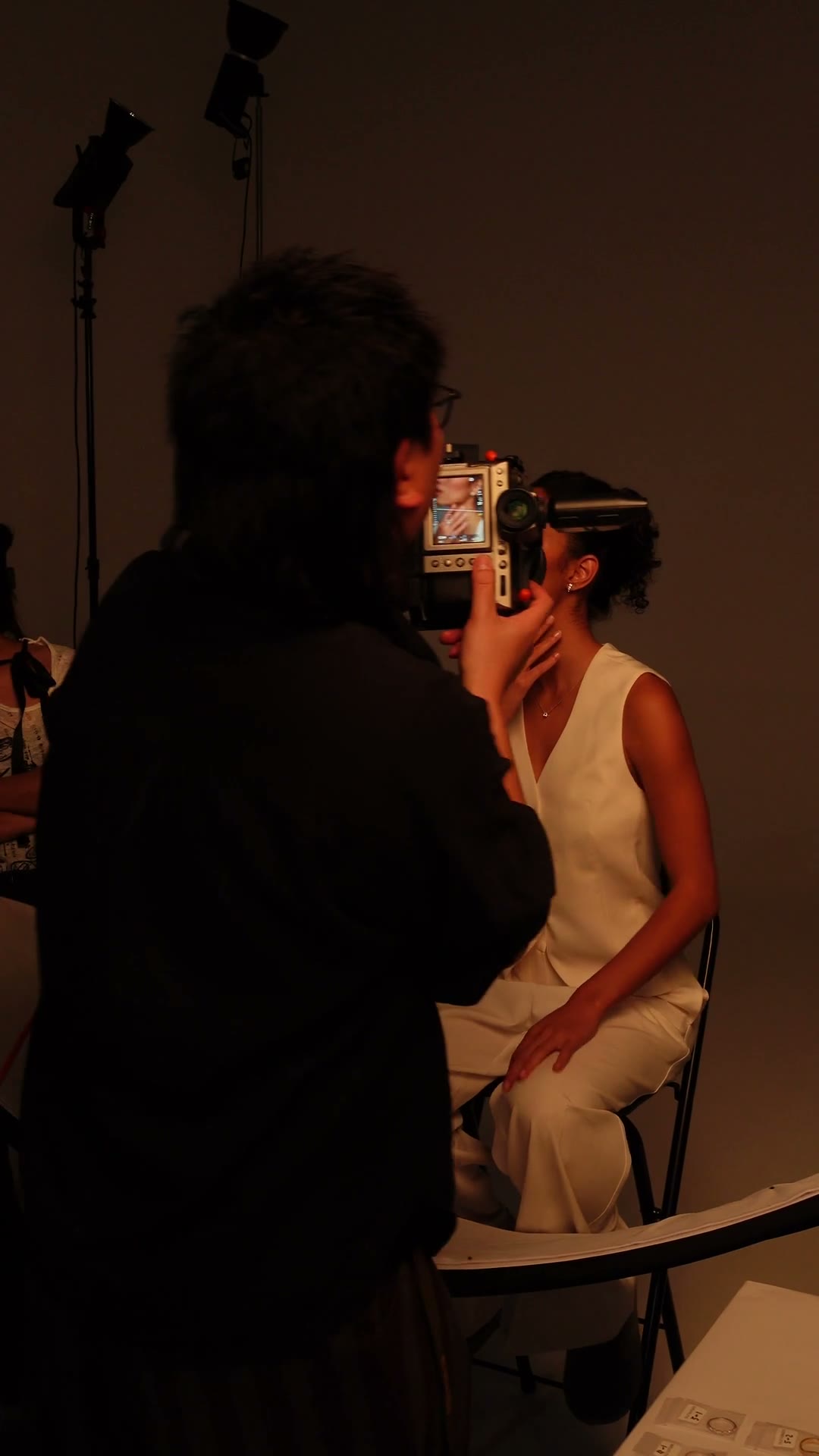 A photographer working with a model on a jewellery shoot