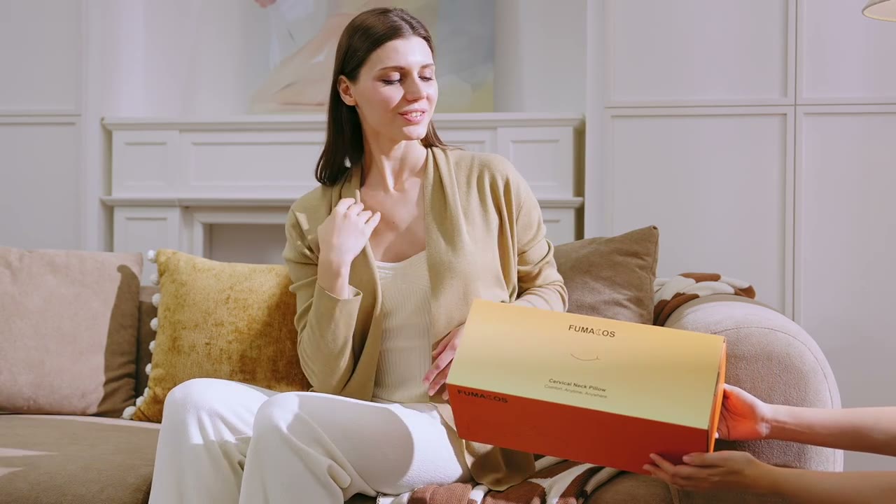 A woman receiving a boxed pillow in a home setting